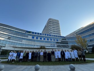 A group of people in front of a buildingDescription automatically generated